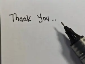 Thank,You,Written,On,White,Paper,With,Black,Pen.,Write